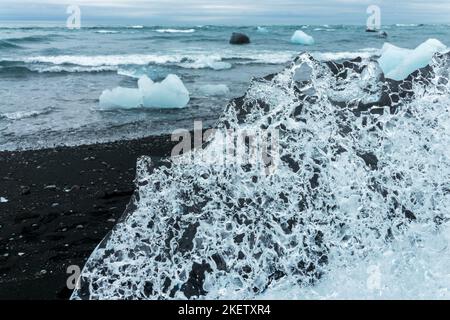 Eisberge und schwarzer Sand am Jokulsarson Diamond Beach, Island Stockfoto