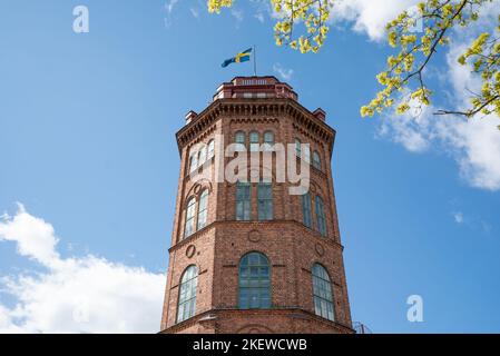 Bredalick: Ein 30 Meter hoher, aus Backstein gebauter Turm in Skansen. Der riesige rote Backsteinturm entlang der Djurgården Skyline von Stockholm Stockfoto