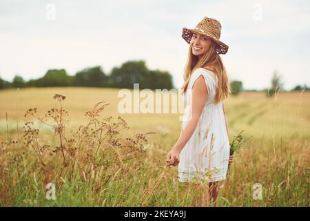 Besser geht es nicht. Eine junge Frau auf einem Weizenfeld. Stockfoto