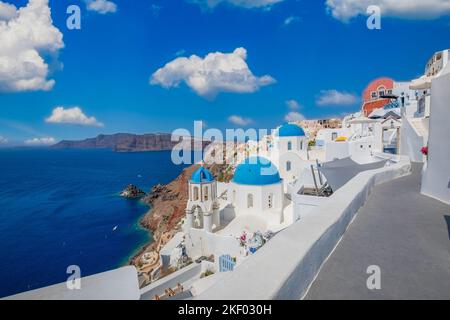 Erstaunliche Panoramalandschaft, Luxus-Urlaub. Oia Stadt auf Santorini Insel, Griechenland. Traditionelle und berühmte Häuser und Kirchen mit blauen Kuppeln Stockfoto