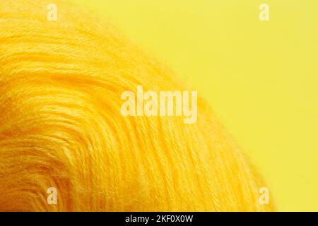 Gelbe Wollrolle zum Stricken auf gelbem Grund. Stockfoto