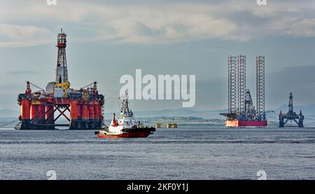 Cromarty Firth Scotland Schlepper Strathdon fährt vor der orangefarbenen Ölplattform Transocean Leader vorbei Stockfoto