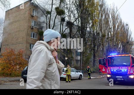 Kiew, Ukraine. 15.. November 2022. Eine Frau kommt an einem Wohngebäude vorbei, das von einem russischen Raketenangriff getroffen wurde, während Russlands Angriff auf die Ukraine in Kiew durchgeführt wurde. (Foto: Aleksandr Gusev/SOPA Images/Sipa USA) Quelle: SIPA USA/Alamy Live News Stockfoto