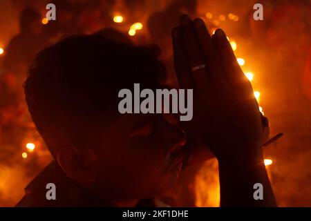 Dhaka, Dhaka, Bangladesch. 15.. November 2022. Hinduistische Anhänger bieten Rakher Upobas Gebete an, umgeben von brennenden Kerzen, am Shri Shri Lokanath Brahmachari Ashram Tempel in Narayanganj am Rand von Dhaka. (Bild: © Abu Sufian Jewel/ZUMA Press Wire) Bild: ZUMA Press, Inc./Alamy Live News Stockfoto