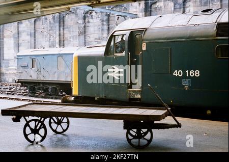 Die alte Eisenbahn - 40168 ex-Scottish Region Class 40 wartet an der Carlisle Citadel Station mit 1E23, der 10,40 nach Leeds - der Fahrer genießt einen ruhigen Rauch. Aufgenommen am 21.. Juli 1984. Stockfoto