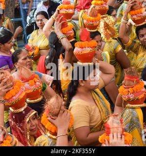 Neu Delhi, Indien April 03 2022 - Frauen mit Kalash am Kopf während des Jagannath-Tempels Mangal Kalash Yatra tragen indische Hindu-Anhänger irdische Töpfe Conta Stockfoto