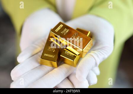 Nahaufnahme eines Mannes, der Goldbarren in den Händen hält. Stockfoto