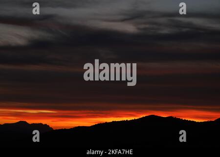 Sonnenuntergang.Sonnenuntergang von Los Rosales in der Nähe von Frailes, Jaen, Andalusien, Spanien. Wolken und untergehende Sonne schaffen Muster und Farben wie auf Feuer.andalusischer Himmel. Stockfoto