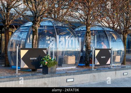 Im Gaucho, einem argentinischen Steak-Restaurant in Westferry, Tower Hamlets, London, Großbritannien, kann man draußen Plexiglas essen Stockfoto