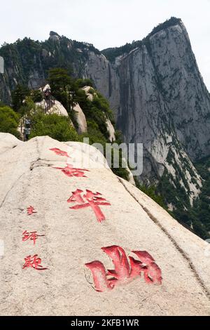 Ausblicke und Landschaften, die Touristen auf dem Wanderweg zum westlichen Gipfel des Huashan Mountain / Mount Hua / Mt Hua bei Huayin, Weinan, China 714299 sehen. Chinesische Schriftzeichen mit roten Zeichen wurden in die Steinoberfläche gehauen. (125) Stockfoto