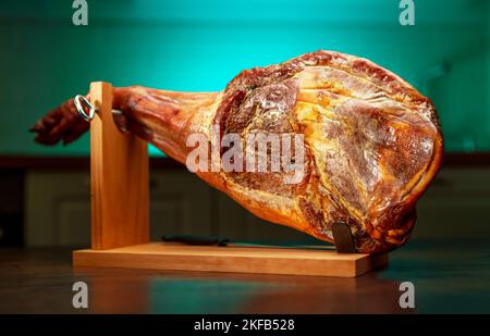 Trockengehärteter spanischer Schinken. Jamon auf einem Holzständer. Stockfoto