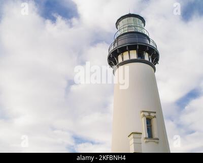 Der majestätische weiße Leuchtturm ruht auf dem wolkigen Himmel. Wunderschönes Gebäude. Ein Ort zum Filmen von Filmen, Werbespots, romantischen Dates. Werbung Stockfoto