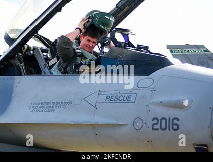 US Air Force Capt. McCall Kerkman, 555. Fighter Squadron F-16C Fighting Falcon Pilot vom 31. Fighter Wing, Aviano Air Base, Italien, legt seinen Flughelm auf, bevor er sein Flugzeug auf der Royal Air Force Base Lakenheath, Großbritannien, rollt, 7. September 2022, Während der Cobra Warrior 2022-Übung der Royal Air Force. Diese Missionen erhöhen die Bereitschaft, auf jede mögliche Herausforderung in der Region zu reagieren. Stockfoto