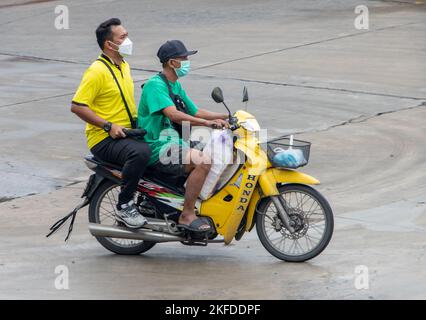 SAMUT PRAKAN, THAILAND, SEP 26 2022, zwei Männer fahren auf dem Motorrad auf der nassen Straße. Stockfoto