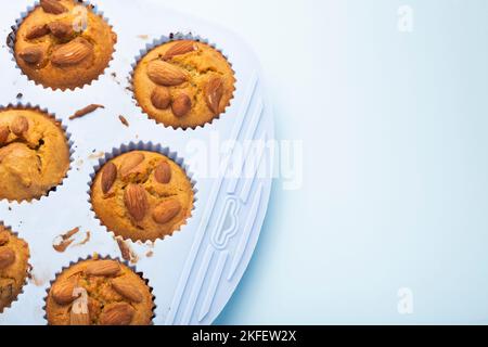 Set mit verschiedenen Backzutaten – Mehl, Eier, Zucker, Butter, Nüsse, Küchenutensilien und Cupcake-Backform auf weißem Hintergrund. Draufsicht. Kopie SPA Stockfoto