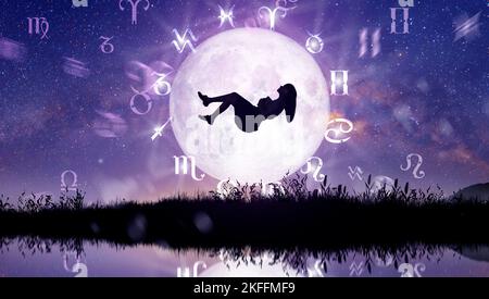 Astrologische Tierkreiszeichen innerhalb des Horoskopkreises. Frau schweben über den Sternen und dem Mond über dem Tierkreisrad und dem Hintergrund der Milchstraße. Stockfoto