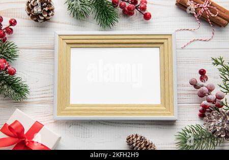 Weihnachtskomposition. Fotorahmen, Dekorationen, Tannenzweige auf weißem Holzhintergrund. Weihnachten, Winter, Neujahr Konzept. Flach liegend, top vie Stockfoto