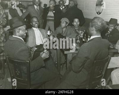 Afroamerikaner unterhalten sich und trinken Bier in einer Bar, Clarksdale, Mississippi Delta, November 1939. Stockfoto