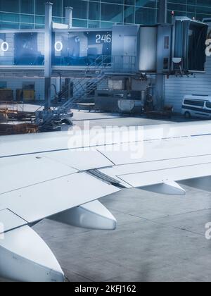 Zugeschnittenes Bild des Flugzeugflügels auf dem Hangar in der Luft- und Raumfahrtindustrie Stockfoto