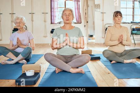 Yoga, Meditation und ältere Frauen mit Zen und Yogi-Instruktor im Fitnessstudio mit Wellness, Gesundheit und Achtsamkeit. Gleichgewicht, spirituell und Frieden Stockfoto