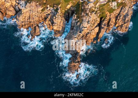 Luftdrohnen-Landschaftsbild des Minnack Theatre Vorgewende um den Porthcurno-Strand in Cornwall England bei Sonnenaufgang Stockfoto