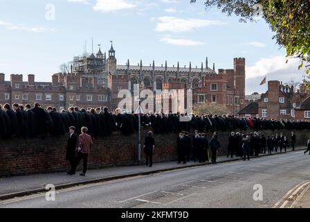 Eton, Windsor, Britannien. 19.. November 2022. Heute war es ein geschäftiger Tag in Eton für das berühmte Eton College Wall Game. Das Spiel entstand am Eton College und wird immer noch gespielt. Es wird jedes Jahr am St. Andrew's Day gefeiert. Eton College Jungen sitzen an der Wand und feuern die Spieler an. Es wird auf einem 5 Meter breiten und 110 Meter langen Streifen gespielt, neben einer leicht gebogenen Ziegelmauer, die 1717 errichtet wurde. Es ist einer von zwei Codes des Fußballs, der bei Eton gespielt wird, der andere ist das Eton Field Game. Ehemalige Schüler Prinz Harry und der Herzog von Cornwall waren Schüler an der Schule, ebenso wie Boris J. Stockfoto