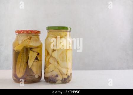 Eingelegte Gurken in einem Glas auf hellem Hintergrund. Hausgemachte fermentierte oder eingelegte Gurken. Stockfoto