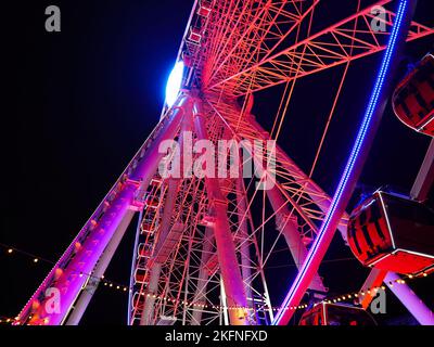 Beleuchtetes Riesenrad am Burgplatz in der Düsseldorfer Altstadt. Es ist eine beliebte Attraktion für Einheimische und Touristen. Stockfoto