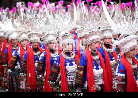 QIANDONGNAN, CHINA - 19. NOVEMBER 2022 - Menschen der ethnischen Gruppe Miao in ihren festlichen Kostümen führen den traditionellen Lusheng-Tanz in Qiandongna auf Stockfoto