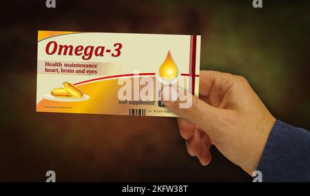 Omega 3 Öltabletten Box in der Hand. Gesunde Ernährung und Diätergänzung Pillen Pack Fabrik. Abstract Concept 3D Rendering Illustration. Stockfoto