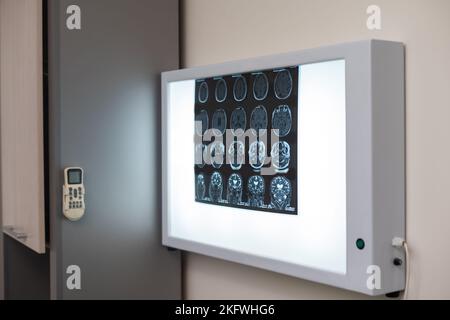 Im medizinischen Labor Patient durchläuft MRI oder CT-Scan-Prozess unter Aufsicht des Arztes und Radiologen im Kontrollraum, sie watche Verfahren und Stockfoto