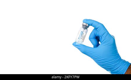 Monkeypox und Pockenvirus-Impfstoffflasche (MPXV) in einer Hand des medizinischen Personals mit horizontalem Kopierbereich auf weißem Hintergrund Stockfoto