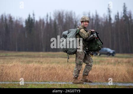 US Army Staff Sgt. Philip Frank, ein Fallschirmjäger, der dem Brigadeingenieur-Bataillon 6. (Airborne), dem Kampfteam der 2.-Infanterie-Brigade (Airborne), der 11.-Airborne-Division (Arctic Angels), zugewiesen wurde, verlässt die Malemute Drop Zone, nachdem er am 20. Oktober 2022 an der Joint Base Elmendorf-Richardson, Alaska, ein Sprungtraining absolviert hat. Nach dem Flugtraining simulierten einige der Fallschirmjäger Sprungopfer für 673d medizinische Gruppenflieger, die an der Arctic Warrior Challenge 2022 teilnahmen. Die Arctic Warrior Challenge war eine szenariobasierte Feldtrainingsübung, die die TA der 673d Medical Group Airmen schärfen sollte Stockfoto