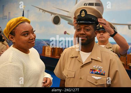 JACKSONVILLE, Florida (Okt. 21, 2022) - Chief Operations Specialist Byron Harris dons his Chief Petty Officer Cover during a CPO Pinning Ceremony Held at Naval Air Station Jacksonville, 21. Oktober 2022. Navy Region Southeast ist die größte Küstenverwaltungsregion innerhalb der US Navy und bietet Unterstützung für 18 Anlagen im Südosten der Vereinigten Staaten. Stockfoto