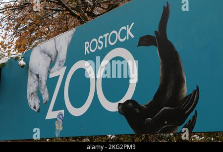 Rostock, Deutschland. 21.. November 2022. Das Rostocker Zoo-Logo ist am Haupteingang zu sehen. Im Rahmen einer Presseveranstaltung stellen der Zoo und die Wiro - Wohnen in Rostock Wohnungsgesellschaft GmbH als Partner ein Projekt für den Roten Panda vor. Der gekonnte Kletterer aus dem Himalaya ist etwa einen Meter groß und laut der World Conservation Union IUCN eine der am stärksten gefährdeten Arten. Es soll nach Renovierungsarbeiten wieder in den Zoo eingeführt werden. Quelle: Bernd Wüstneck/dpa/Alamy Live News Stockfoto