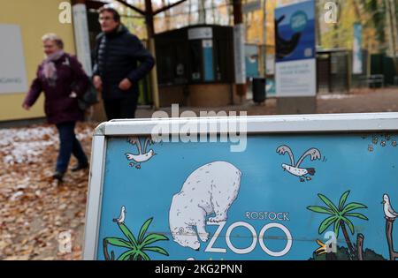 Rostock, Deutschland. 21.. November 2022. Am Haupteingang steht ein Display mit dem Rostocker Zoo-Logo. Im Rahmen einer Presseveranstaltung stellen der Zoo und die Wiro - Wohnen in Rostock Wohnungsgesellschaft GmbH als Partner ein Projekt für den Roten Panda vor. Der gekonnte Kletterer aus dem Himalaya ist etwa einen Meter groß und laut der World Conservation Union IUCN eine der am stärksten gefährdeten Arten. Es soll nach Renovierungsarbeiten wieder in den Zoo eingeführt werden. Quelle: Bernd Wüstneck/dpa/Alamy Live News Stockfoto