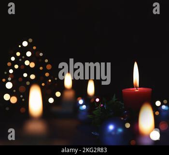 Glitzernde Kirchendekorationen, hell beleuchtete Kerzen und heller Hintergrund zur Feier der Weihnachten Jesu Christi Stockfoto