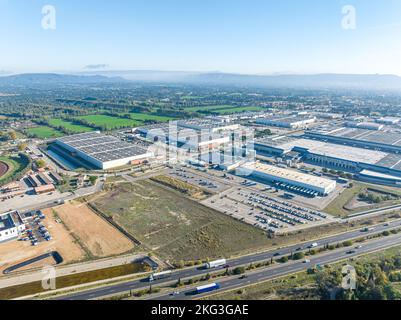 Panoramablick auf das Industriegebiet von oben, umgeben von Hauptverkehrsstraßen und Grünflächen auf der anderen Seite Stockfoto