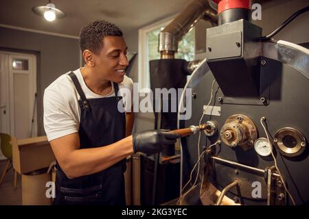 Braten Master Überprüfung des Roastgrades von Kaffeebohnen Stockfoto