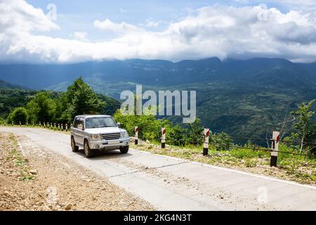 Geländewagen im Geländewagen auf einer Schotterstraße bergauf in Richtung Khvamli Mountain Peak im üppig grünen Tskhenistsqali-Tal in der Racha-Region in Georgien. Stockfoto