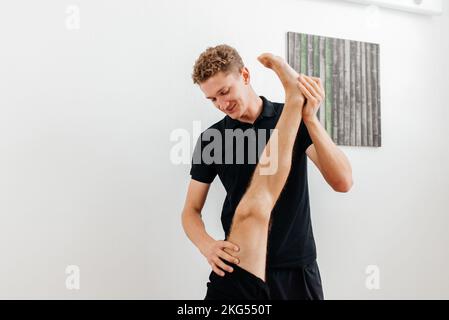 Massagesportpatient - das Konzept der Physiotherapie Stockfoto