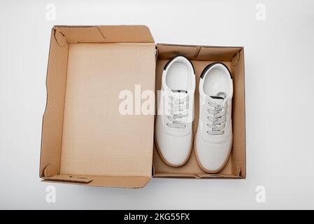 Bequeme Freizeitschuhe in Karton auf weißem Hintergrund, Draufsicht. Platz für Text Stockfoto