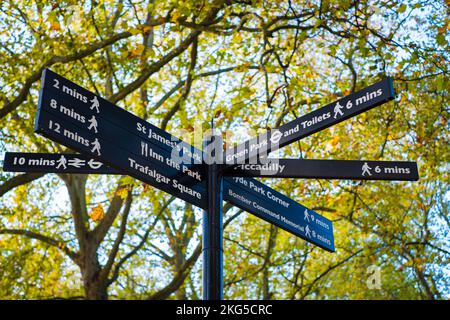 Pfeile zeigen verschiedene beliebte Wegbeschreibungen und Gehwege in der Touristengegend von London an. Sightseeing-Schild in London. Stockfoto