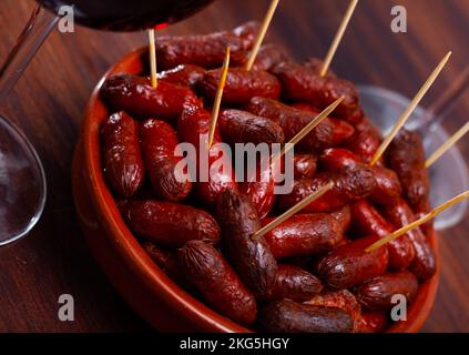 Heiße spanische Würstchen, Chistorritas auf Spieße Stockfoto