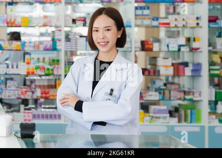 Porträt eines jungen Affable-Apothekers und qualifizierter Pharmazie-, Medikamenten-Pillen-Behältnis- oder Flaschenmodell für Kopierraum in der Apotheke. Ein Drogendealer Stockfoto