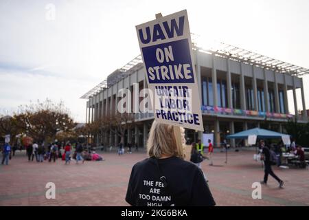 Berkeley, Usa. 21.. November 2022. Ein Protestler hält ein Plakat während der Demonstration an der University of California Berkeley. Studenten Forscher und Arbeiter der University of California haben seit Mitte November 2022 geschlagen. Die Streikenden behaupten, dass der Lohn nicht fair sei und nicht ausreicht, um in Kalifornien zu leben. Sie wollen die University of California zwingen, ihre Löhne durch Streik und Demonstration zu erhöhen. Auf dem Campus der University of California in Berkeley begannen die Streikenden in der zweiten Woche ihren Streik. Kredit: SOPA Images Limited/Alamy Live Nachrichten Stockfoto