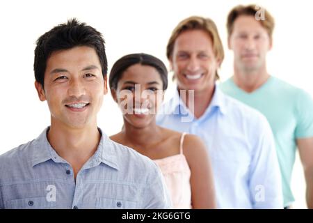 Vielfalt am Arbeitsplatz. Kleine Gruppe von vier lächelnden Erwachsenen mit unterschiedlichen Rassen und Ethnien. Stockfoto