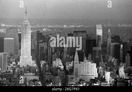 An einem grauen Wintertag, etwa im Jahr 1983, schwammen Sonnenstrahlen über das Empire State Building und andere Wolkenkratzer in Midtown Manhattan. Stockfoto