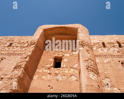 Eine flache Ansicht der abgerundeten Wand nahe dem Eingang des Qasr Kharana in Jordanien Stockfoto