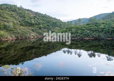 Vanadal-Wasserretention mit Wolken, die sich im Wasser spiegeln, in La Garde-Freinet, im Massif des Maures, in Südfrankreich, in Europa, in der Provence. Stockfoto